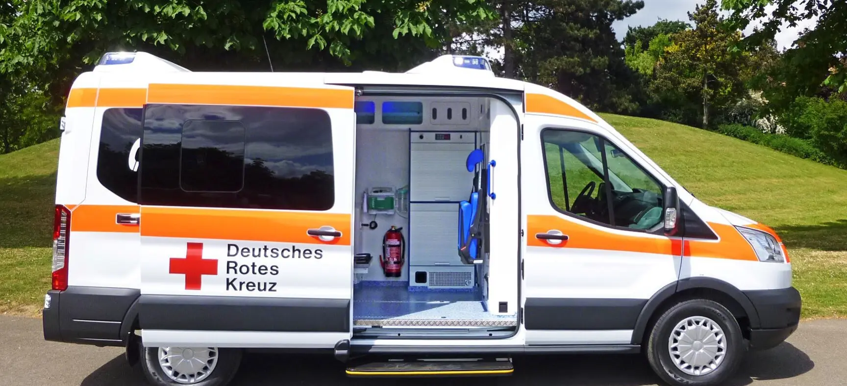 Rettungswagen des Deutschen Roten Kreuzes mit geöffneter Seitentür und Blick ins Fahrzeuginnere.