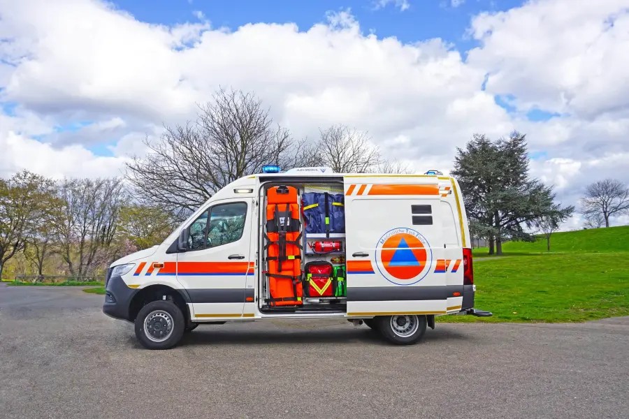 Zivilschutz-KTW seitlich mit geöffneter Tür und Notfallausrüstung.